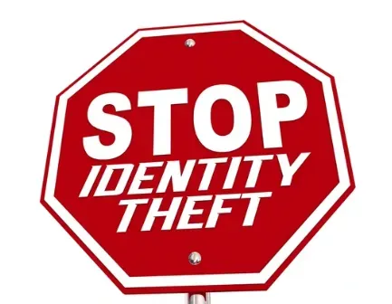 Red octagonal road sign reading "Stop Identity Theft"