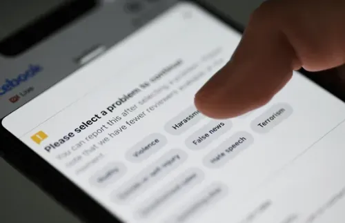 Finger tapping a Facebook report menu with options like harassment and false news