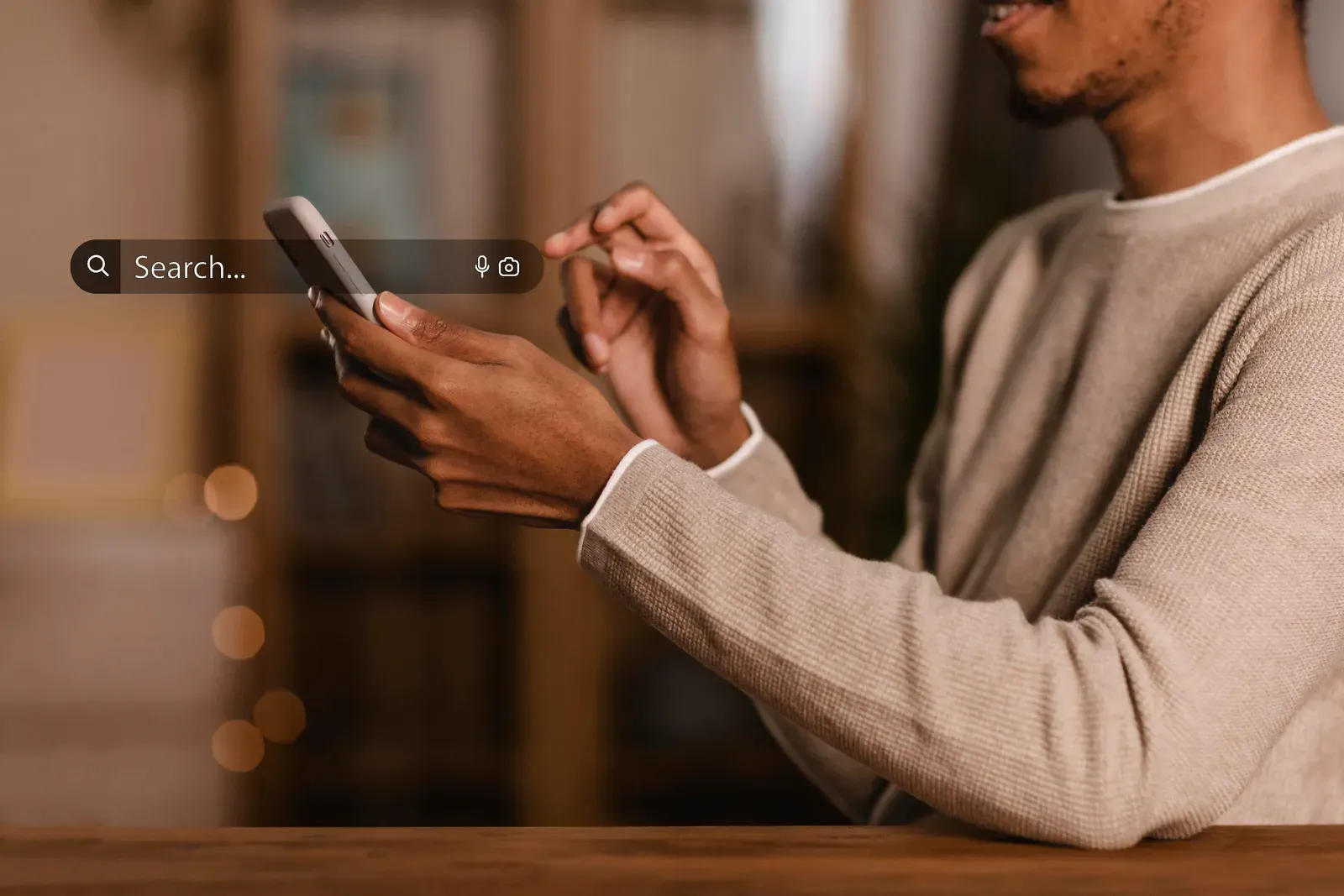 Man using a smartphone with a search bar overlay hovering above the screen