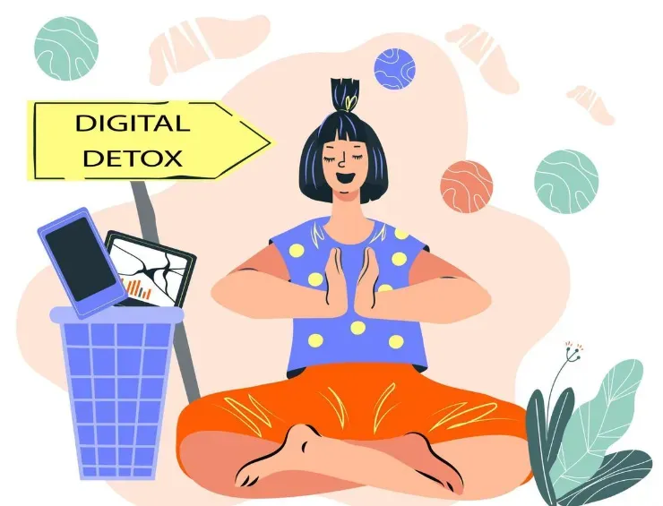 Woman meditating beside a 'Digital Detox' sign with a phone and tablet tossed in a bin